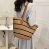 Bolso nuevo de paja tejida 2026 para vacaciones en la playa junto al mar, gran capacidad, versátil para el trabajo diario, bolso de hombro tipo tote tejido