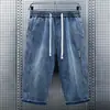 Pantalones cortos de mezclilla de siete puntos para hombre, pierna recta holgada, cordón, por encima de la rodilla, culottes, comercio exterior, verano, estilo fino, pantalones casuales de 7 puntos