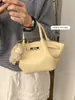 Bolsa Única com Textura Pequena Tote Bag para Mulheres 2026 Estilo Novo da Primavera Bolsa de Cesta Simples Ombro Transversal Bolsa Asa