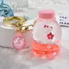 Lindo llavero de botella de arena movediza con gato KT, gatito de dibujos animados creativo, colgante para mochila escolar de estudiante, llavero para coche, baratijas