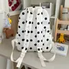 Mochila de estilo coreano con lunares y un fresco dije de tulipán, una bolsa escolar de gran capacidad, una mochila versátil y casual para estudiantes