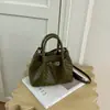 2026 Bolso mini cubo con patrón de tejido francés diseño de hebilla de cuero bolso de mano de nicho bolso de hombro bolso de mujer para commuting bolso cesta de frutas