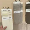 Nuevos Calcetines Suaves de Otoño e Invierno con Rayas Verticales de Color Sólido Hilo Peinado Color Coreano Gris Crema Calcetines de Felpa Calcetines de Media Pantorrilla