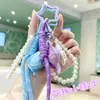 Colgante de concha curativa de moda, pulsera tejida, llavero de cadena de perlas, charm de bolso girly creativo, venta al por mayor