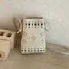Moda versátil transfronteriza con diseño único, bolso cubo tejido calado, bolso de hombro fresco y dulce, bolso de mano que realza tu apariencia