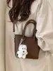 Bolso Cubo de Mano Estilo Coreano de Nicho para Mujer 2026 Modelo Nuevo de Primavera Textura de Alta Calidad Bolso Cruzado de Hombro Casual Súper Popular