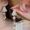 Pendientes de borla de concha de hada súper pendientes colgantes de pétalo súper hada temperamento pendientes femeninos al por mayor pendientes de nicho de alto sentido pendientes