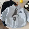 Camisas para Niños 2026 Otoño Nuevo Estampado Digital Dibujos Animados Camisas Personalizadas Bebé Estilo Coreano Versátil Camisas de Algodón de Color Sólido