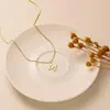 Europa y Estados Unidos venta transfronteriza exquisito collar personalizado de 26 letras moda mujer simple colgante de cobre joyería transfronteriza venta al por mayor