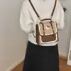 Mochila nicho fresca desenho animado 2026 mochila para ir ao trabalho novo estilo feminina estilo fofo pequena versão coreana escola estampa de leopardo moda
