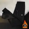 Pantalones deportivos casuales holgados para hombre, nuevos y modernos, forrados de polar para invierno, con bolsillos, cremallera, estilo jogger, pantalones de chándal largos rectos