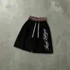 Pantalones cortos de retazos a cuadros estilo retro americano transfronterizos, pantalones deportivos holgados de longitud hasta la rodilla con cordón estampado, únicos y elegantes