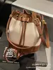 Bolsos de Diseño Nicho para Mujer 2025 Nuevo Verano Versátil Super Popular Bolso Cruzado Estilo Coreano Cordón Mini Bolso Cubo