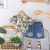 Ropa de Moda para Niños Niños, Verano 2026 Estilo Nuevo, Conjunto de Dos Piezas con Camiseta de Manga Corta Estampado Completo de Letras y Shorts de Mezclilla para Niños