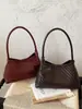 Bolso de mano de nicho de moda estilo francés, nuevo modelo 2026, diseño tejido elegante y simple, sensación de alta gama, bolso de hombro único para debajo del brazo