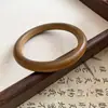 Pulsera redonda de madera retro estilo chino nueva, única y elegante, joyería de nicho de lujo ligero de alta gama al por mayor