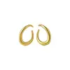 Pendientes de anillo retorcido minimalistas europeos y americanos de aguja plateada, pendientes de lujo ligero de alta gama, pendientes de diseño único de nicho al por mayor