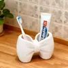 Portacepillos de dientes con forma de lazo, soporte de almacenamiento de plástico sin instalación, adorno de exhibición de bolígrafos y cepillos de dientes para baño y dormitorio
