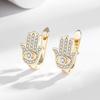 Pendientes de explosión transfronterizos europeos y americanos chapados en cobre con microincrustaciones de oro real y circonitas en forma de ojo de diablo, exquisitos pendientes de fiesta de moda.