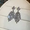 Pendientes colgantes de rombos con borlas tachonados de diamantes de aguja de plata transfronterizos europeos y americanos, pendientes exquisitos y de moda, pendientes versátiles y elegantes al por mayor