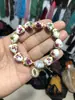 Pulsera de Porcelana Azul y Blanca con Cuentas de Forma Irregular Pulsera Cerámica con Cruz al por Mayor Colgante con Letras Wwjd Joyería al por Mayor