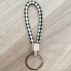 Llavero de cuerda de cuero trenzado simple creativo colgante de muñeca linda accesorios de llave para parejas tendencia regalos pequeños venta al por mayor
