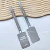 Etiqueta de hebilla de papel antidesgarro punto ropa zapato bolsa anti-falsificación hebilla personalizada desechable hebilla antirrobo a prueba de desgarros anti-ajuste