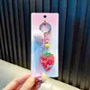 Chaveiro Criativo de Fatia de Goiaba Pingente de Morango com Pom-pom para Mochila Meninas Corda Trançada Ornamento Pendurado Pequeno Presente Atacado