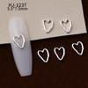 Nuevos accesorios de aleación para decoración de uñas con forma de corazón torcido tridimensional liso con diseño de amor hueco retro japonés