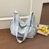 Bolso de Tela de Nylon de Nicho para Mujer 2026 Nuevo Modelo Bolso de Hombro para Estudiante para Clase Viajes al Trabajo Bolso Cruzado Bolso Casual Tipo Dumpling