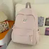 Nueva mochila escolar de alta gama transfronteriza para estudiantes de secundaria femeninas, estilo universitario, color sólido, gran capacidad, simple, versátil.
