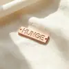 Accesorios de ropa aleación de zinc etiqueta metálica cuadrada logo en inglés nombre de marca placa metálica perforada accesorios de ferretería cosidos a mano