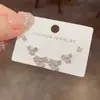 Moda coreana, elegante y simple, juego de pendientes de metal de tres piezas con forma de trébol y incrustaciones de diamantes, pendientes de diseño versátil y de lujo ligero personalizados