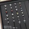 Nuevos y modernos aretes de cruz con diamantes completos Jiuhan para mujer, ear cuffs de acero de titanio de nicho, populares tachuelas de hueso de la oreja de alta gama