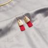Pendientes de escarcha con costuras en contraste de color mate de Corea del Sur, populares en línea, estilo francés perezoso, pendientes redondos que adelgazan el rostro y combinan con todo para otoño e invierno.