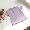 Novos Tops Versáteis de Cores Doces Frescas para Meninas, Camisetas da Moda de Cor Sólida com Laço Fofo para Bebês Meninas