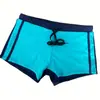 2024 comercio exterior transfronterizo nuevo color sólido costura cintura baja bóxer para hombre shorts de natación para playa cordón en stock al por mayor