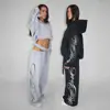 Pantalones Largos Estampados High Street Europeos y Americanos 2026 Pantalones Deportivos que Muestran la Cintura Sudadera con Capucha Pantalones Sueltos con Estampado de Graffiti High Street Europeos y Americanos