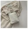 Mini bolso para teléfono móvil con colgante de corazón de lunares de color sólido estilo coreano transfronterizo, bolso de mano de cuero suave, bolso cruzado para niñas