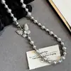 Collar de perlas Shijia con lazo de circonita microincrustada, cadena para suéter de temperamento simple, cadena para clavícula de perla rosa manta