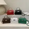 Bolsa de Mão com Fecho de Torção Padrão Crocodilo para Mulheres 2026 Nova Coleção Primavera Estilo Coreano Versátil Bolsa de Ombro Elegante Simples Tendência