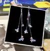 Joyería de moda coreana nuevo deseo Amazon AliExpress ebay pendientes de botón con borla de mariposa de cristal al por mayor