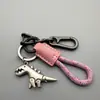 Lindo llavero de dinosaurio de dibujos animados, exquisito llavero para coche de niña, anillo de llavero con cordón de cuero, colgante para mochila