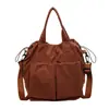 Nova bolsa de tecido de comércio exterior, bolsa de mão versátil de cor sólida simples estilo japonês, bolsa de ombro e transversal casual de grande capacidade para o dia a dia, moderna