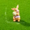 Nuevo producto transfronterizo: Lindo peluche de conejo sosteniendo un huevo de Pascua, accesorios de decoración DIY, mini adornos colgantes