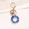 Llavero Azul Real de Venta Caliente Transfronteriza con 26 Letras Inglesas Mayúsculas y Decoración de Ojo Maligno para Bolsos de Mujer