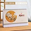 Calendário de Mesa Elevado 2027 Personalizado Novo Calendário de Mesa com Suporte em Papel Pérola Hot Stamping Publicidade Ano do Carneiro Calendário de Mesa Presente Atacado