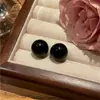 Nuevos pendientes de bola negra 2023 para mujer, aguja de plata de ley 925, diseño de nicho, temperamento simple, pendientes versátiles, venta al por mayor