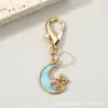 Llavero combinado de pentagrama calado y luna creciente transfronterizo, colgante de mochila de estrella y luna de esmalte colorido con cierre de langosta, accesorio pequeño