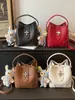 Bolso tipo cubo nuevo para principios de otoño de 2026, bolso cruzado de hombro elegante de color liso, único y a la moda, bolso de mano de alto valor estético